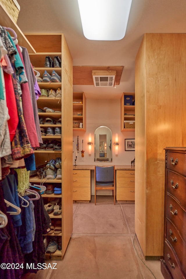 walk in closet with built in desk