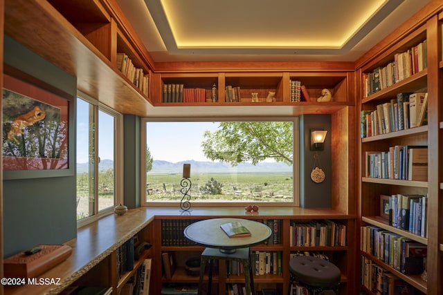 sitting room featuring built in features and wall of books