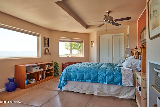 bedroom with ceiling fan, a closet, and tile patterned flooring