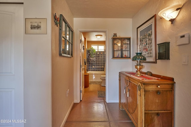 hall featuring baseboards