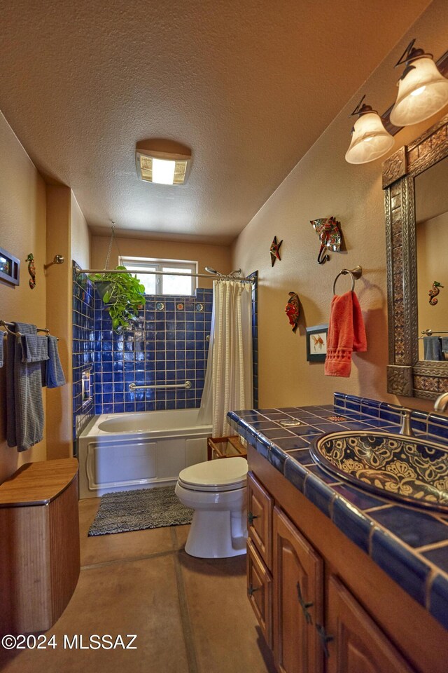 full bath with vanity, toilet, a textured ceiling, and shower / bathtub combination with curtain