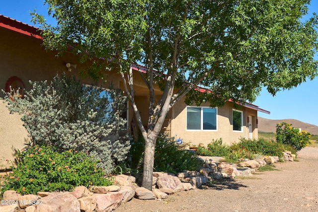 view of side of property with a mountain view