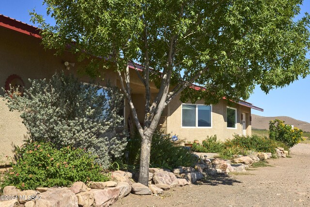 view of side of property featuring stucco siding