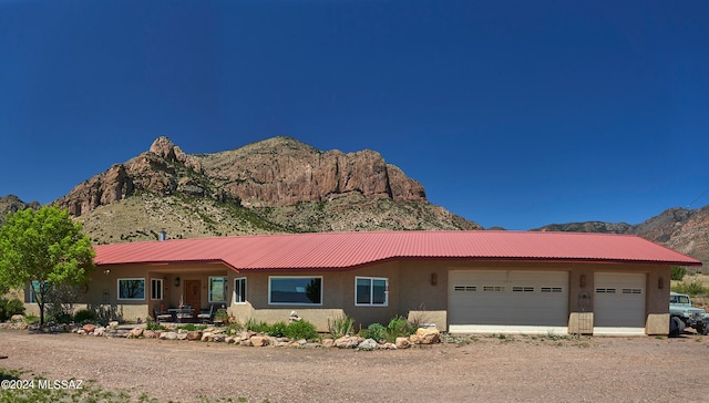 ranch-style home featuring a mountain view and a garage