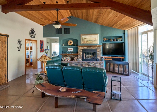 living room featuring lofted ceiling with beams, ceiling fan, a stone fireplace, wood ceiling, and built in shelves