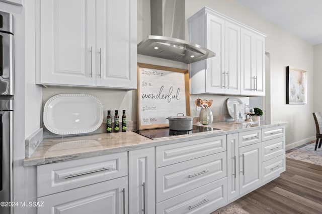 kitchen featuring white cabinetry, dark wood-style flooring, black electric cooktop, and wall chimney range hood
