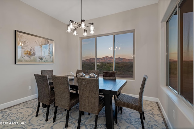 dining area featuring baseboards and a chandelier