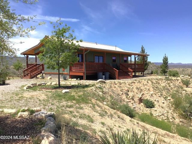 back of property featuring a deck