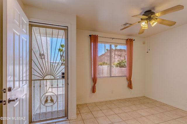 unfurnished room featuring ceiling fan and light tile floors