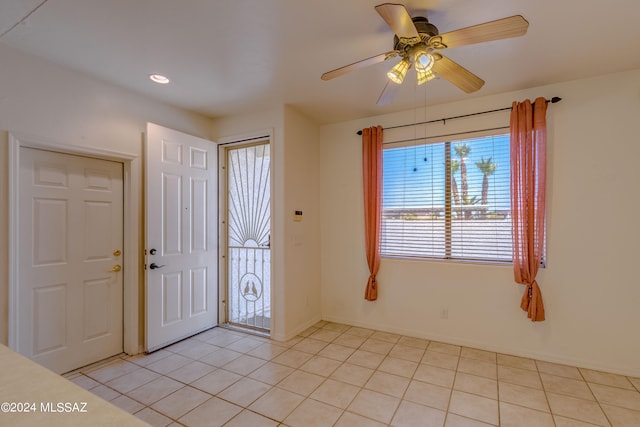 tiled foyer featuring ceiling fan