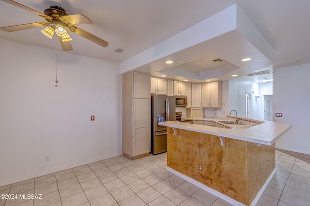 kitchen featuring light tile flooring, kitchen peninsula, stainless steel appliances, ceiling fan, and sink