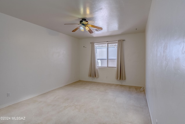 spare room featuring carpet floors and ceiling fan