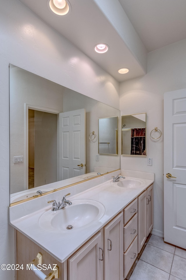 bathroom with tile flooring, oversized vanity, and dual sinks