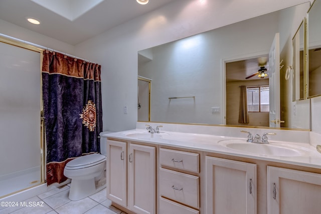 bathroom with dual vanity, toilet, ceiling fan, tile flooring, and walk in shower