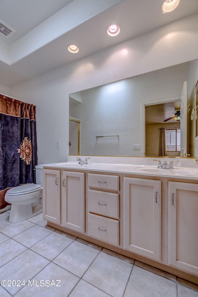 bathroom with dual vanity, toilet, ceiling fan, and tile floors