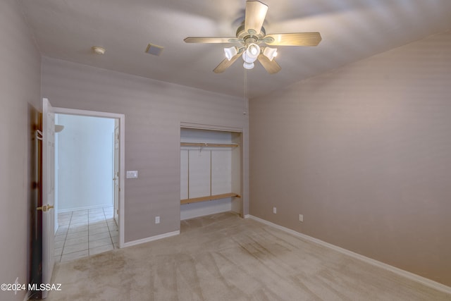 unfurnished bedroom with a closet, ceiling fan, and light tile floors