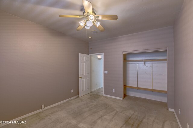 unfurnished bedroom with ceiling fan, a closet, and light colored carpet