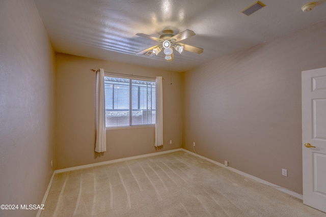 empty room featuring ceiling fan and carpet flooring