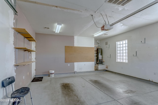 garage with a garage door opener and gas water heater