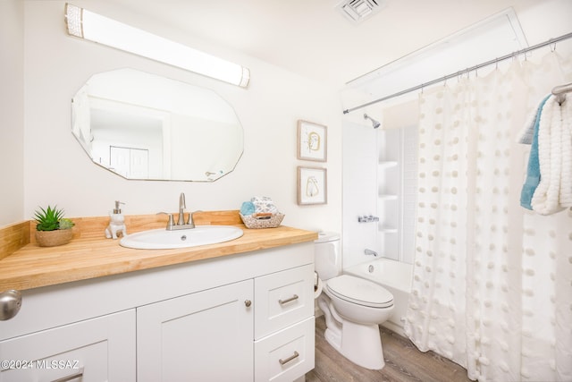 full bathroom featuring vanity, toilet, hardwood / wood-style flooring, and shower / bath combo