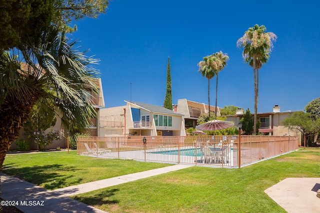 view of swimming pool with a yard and a patio area