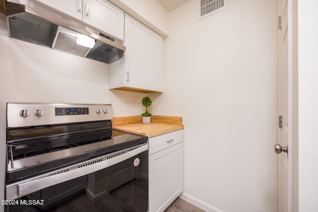 kitchen with stainless steel range with electric cooktop, wood-type flooring, and white cabinetry