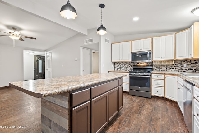 kitchen featuring backsplash, stainless steel appliances, lofted ceiling with beams, and hanging light fixtures