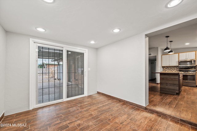 spare room featuring dark hardwood / wood-style floors