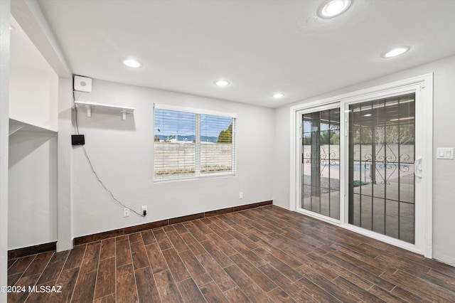 empty room featuring dark hardwood / wood-style floors and a wealth of natural light