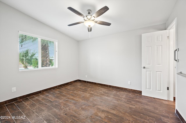 unfurnished room featuring ceiling fan, dark wood-type flooring, and lofted ceiling