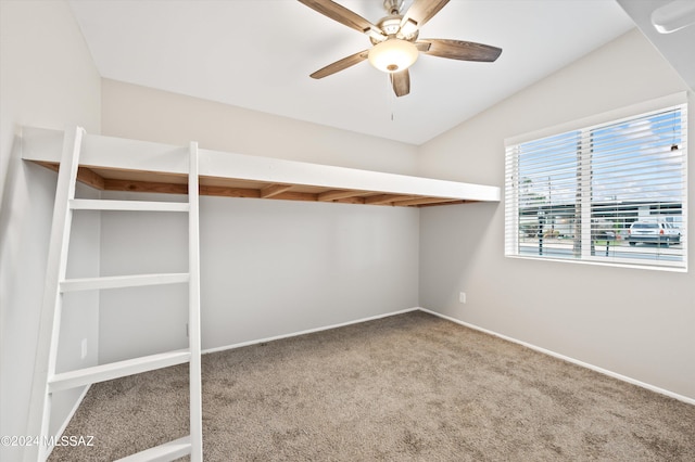 spacious closet featuring lofted ceiling, carpet floors, and ceiling fan