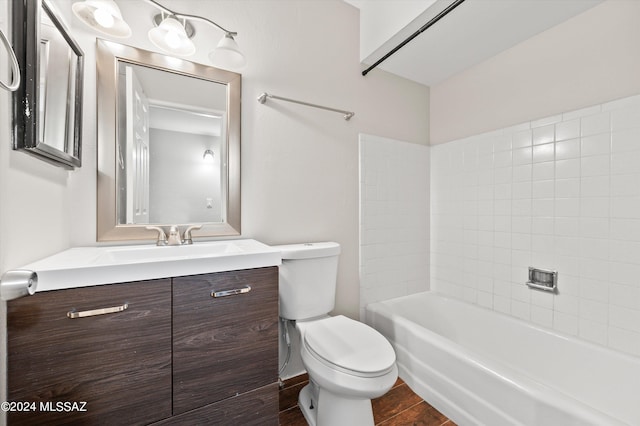 full bathroom with vanity, tiled shower / bath combo, and toilet