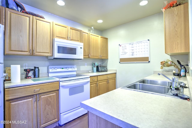 kitchen with sink and white appliances