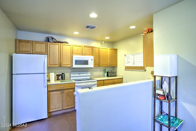 kitchen featuring kitchen peninsula and white appliances