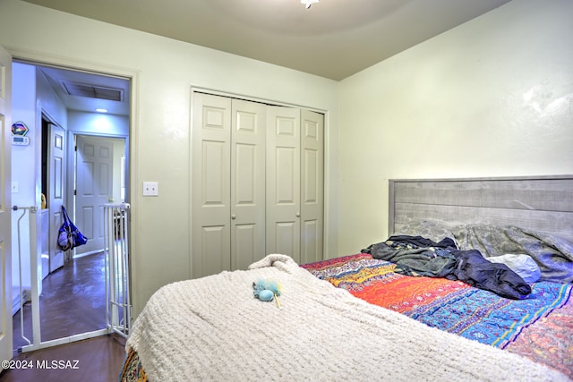 bedroom featuring dark hardwood / wood-style floors and a closet