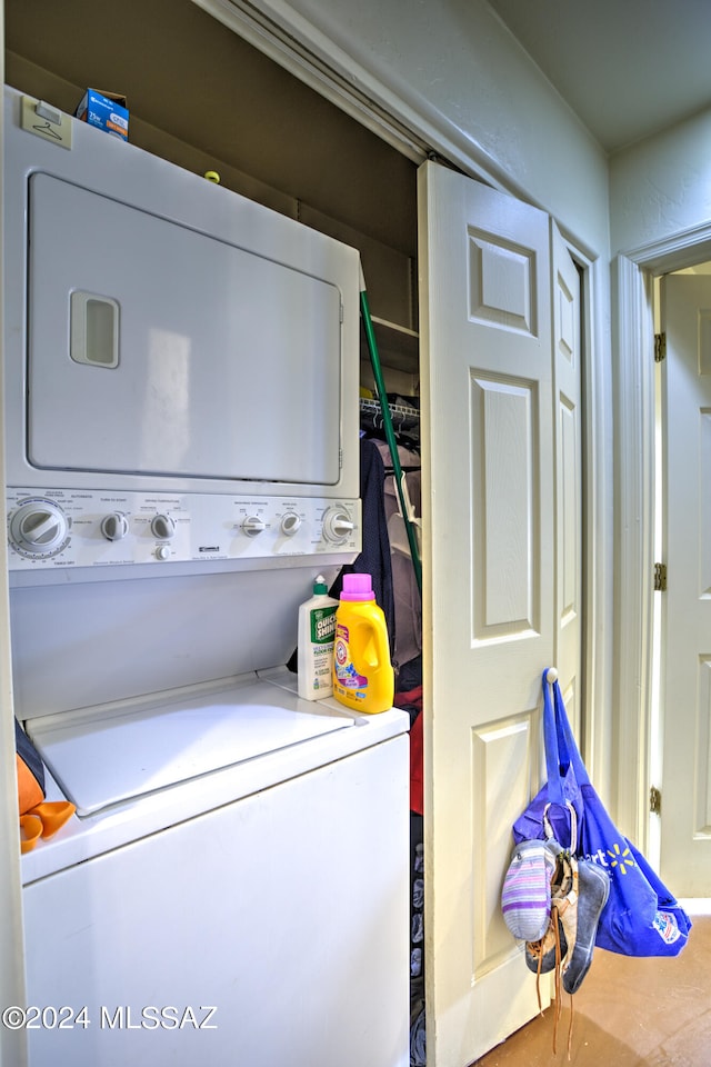 clothes washing area featuring stacked washer / dryer