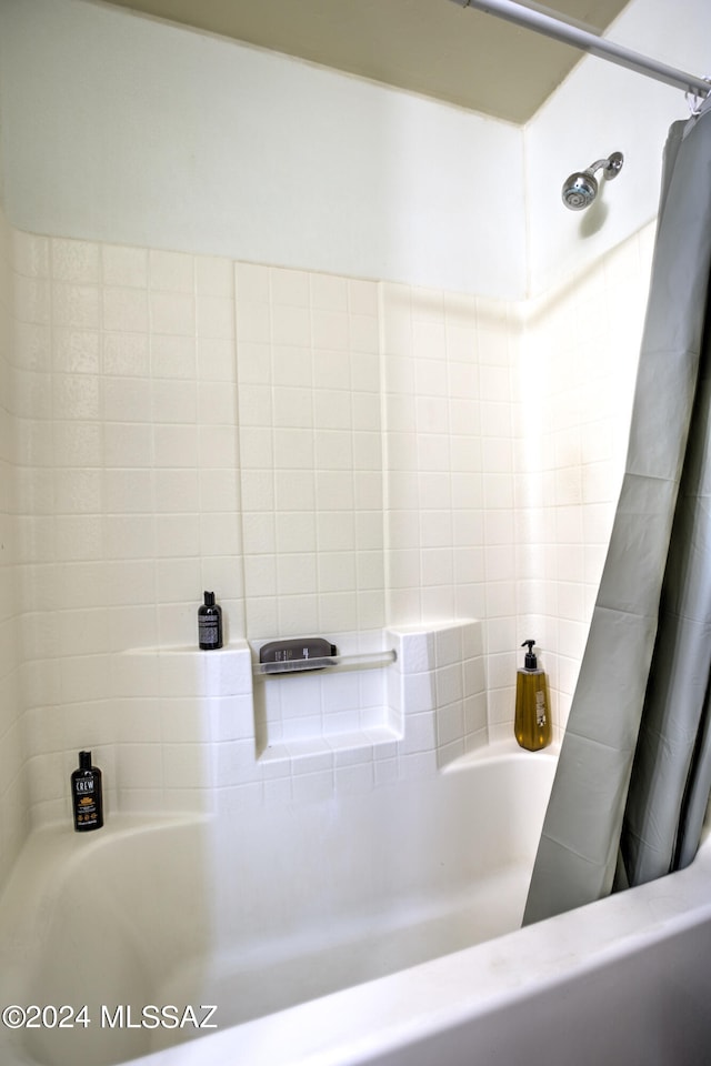 bathroom with shower / bath combination with curtain