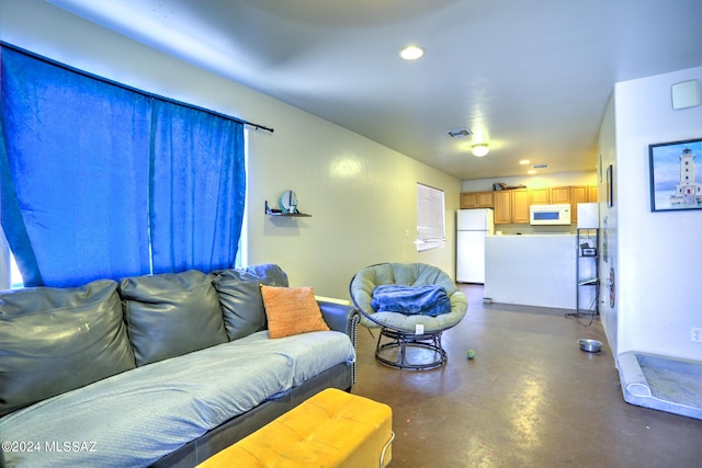 living room featuring concrete flooring