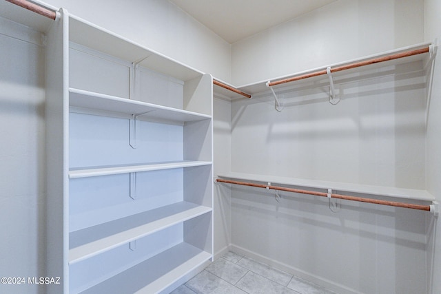 spacious closet featuring light tile patterned flooring