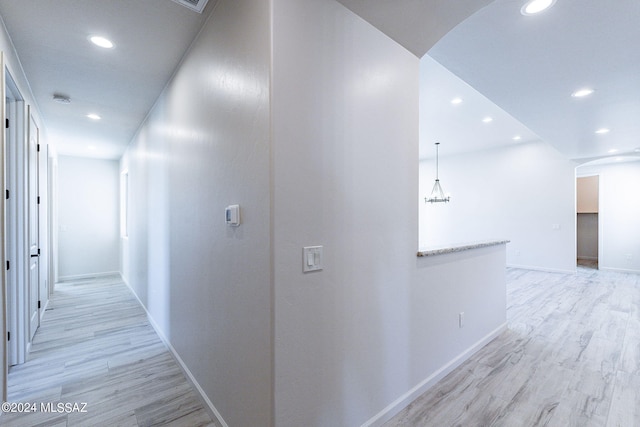 hallway with light hardwood / wood-style flooring