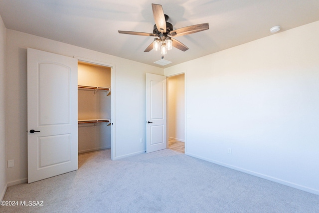 unfurnished bedroom featuring a closet, light colored carpet, and ceiling fan