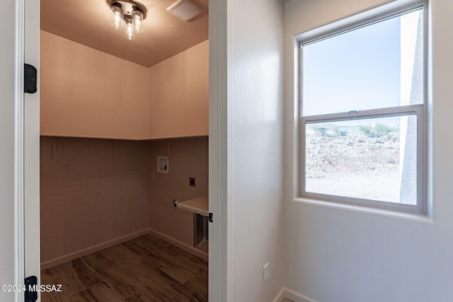 laundry area featuring electric dryer hookup, dark hardwood / wood-style floors, and hookup for a washing machine