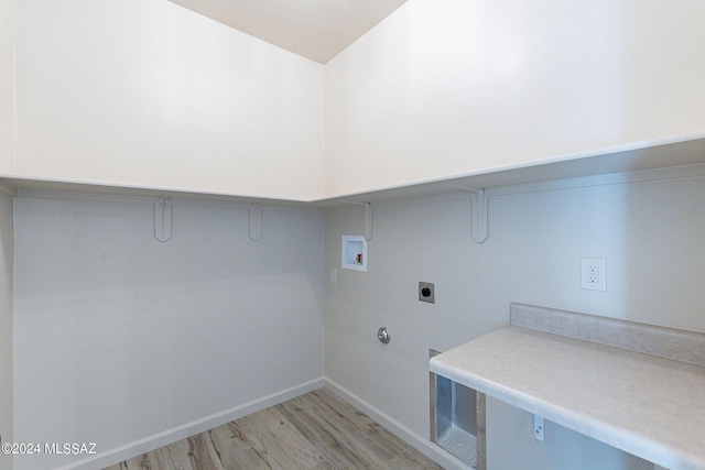 laundry area with hookup for an electric dryer, light hardwood / wood-style floors, and washer hookup