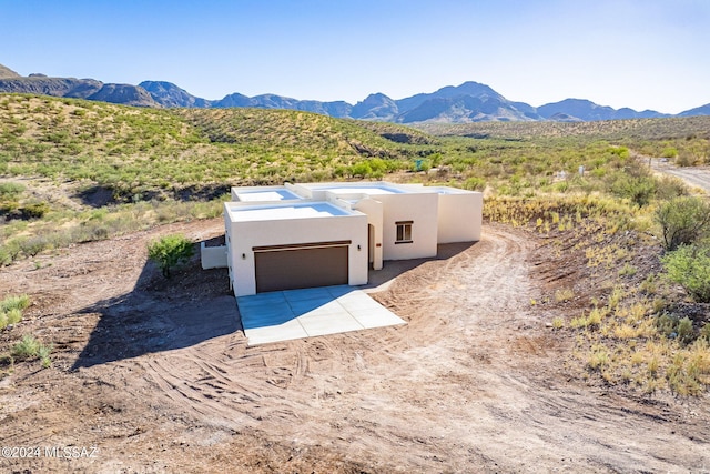 view of front of house featuring a mountain view and a garage