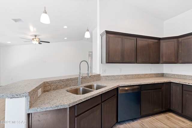 kitchen with pendant lighting, dishwasher, sink, and light hardwood / wood-style flooring