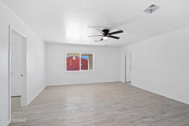 unfurnished room with light hardwood / wood-style flooring and ceiling fan
