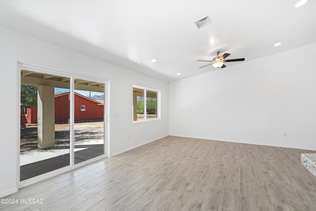 spare room with ceiling fan and light hardwood / wood-style floors