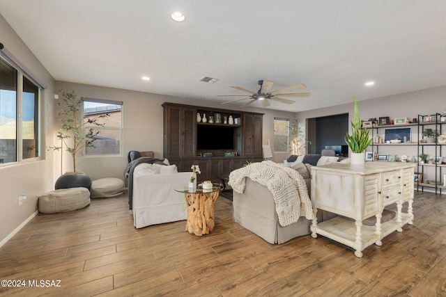 living room with wood-type flooring and ceiling fan