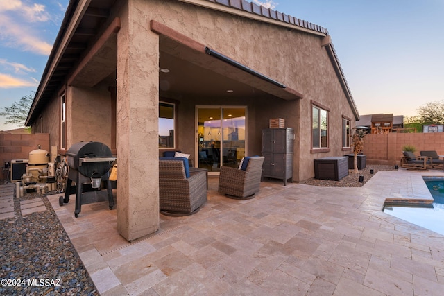 patio terrace at dusk with a grill