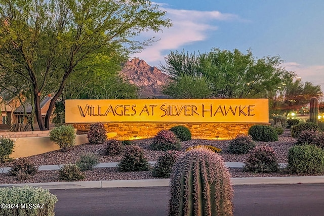 community sign with a mountain view